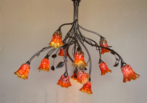 This Art Nouveau Chandelier was designed and fabricated 
											with metal artist Tammy Grubisha, featuring flower shaped 
											shades in sunset colors.  This piece is aprox. 8 feet tall 
											x 5 feet across.