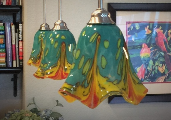 Inspired by the clients' love of tropical birds and
											Mexican beach house colors, these festively colored lights
											are an example of the tailoring that is designed into many
											of Brice's commissions to warm and personalize home and
											business spaces.